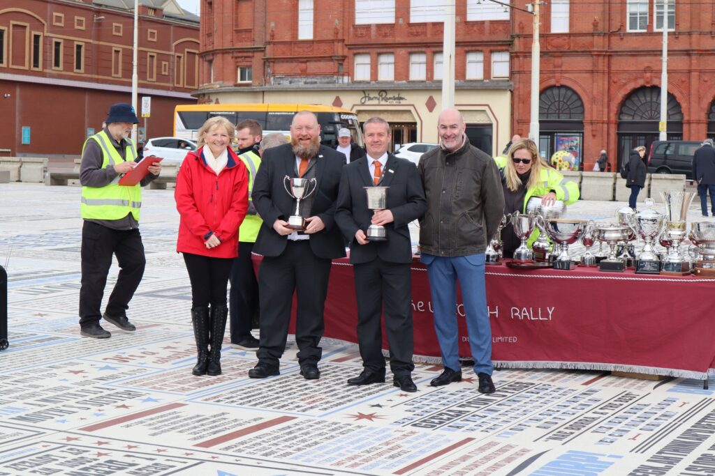 Motorcoaches drivers with the judges in Blackpool, holding their trophies.